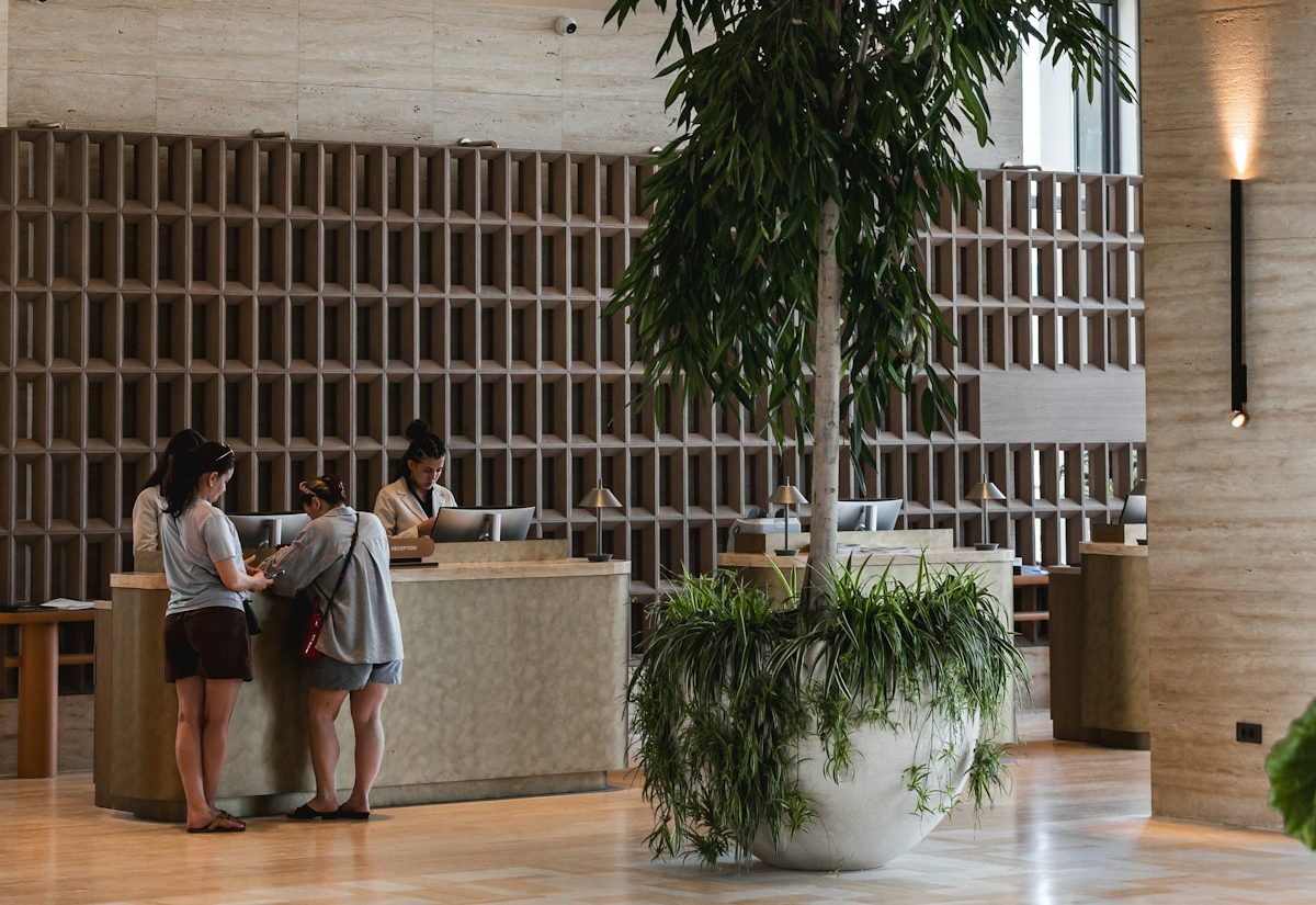 Guests checking in at a hotel reception desk